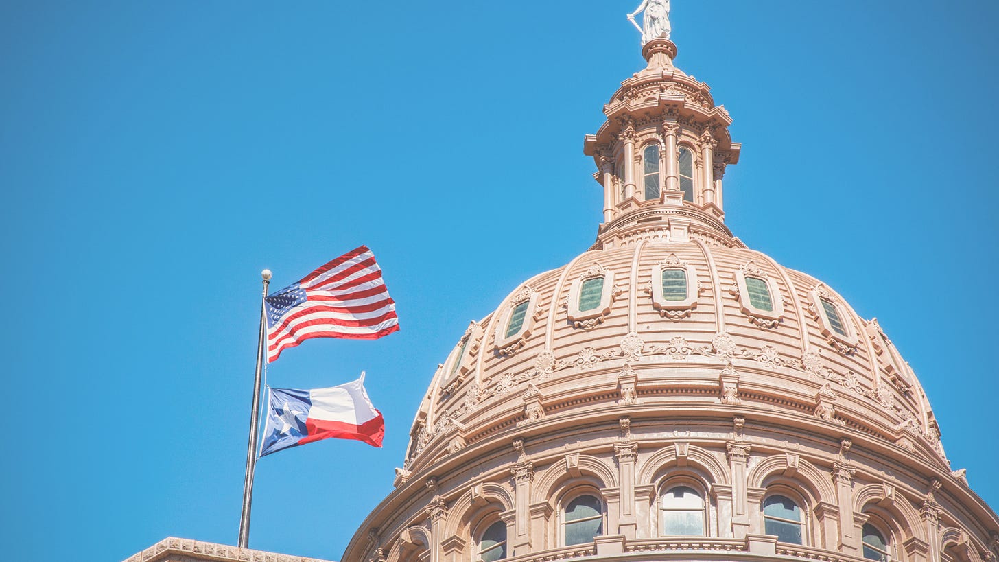 a structure with flags of USA and Texas