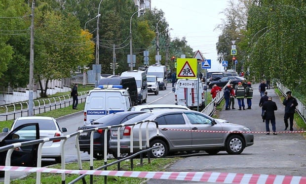 Police and members of emergency services work near the scene of a school shooting in Izhevsk, Russia.