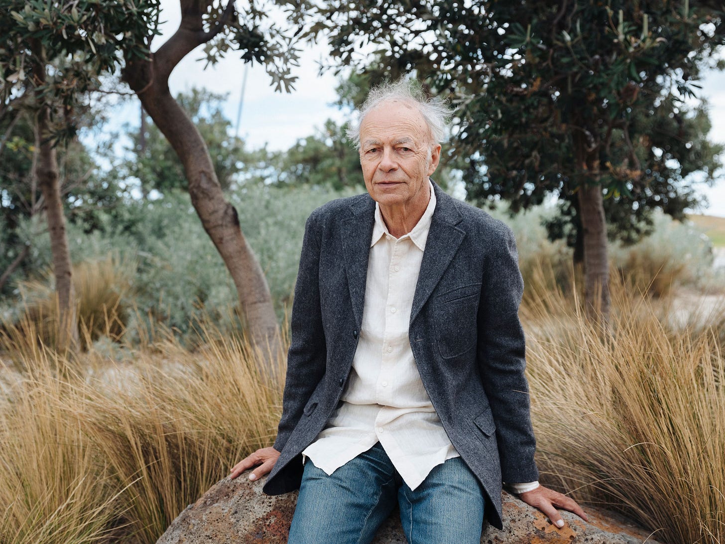 Portrait of philosopher Peter Singer sitting on a rock