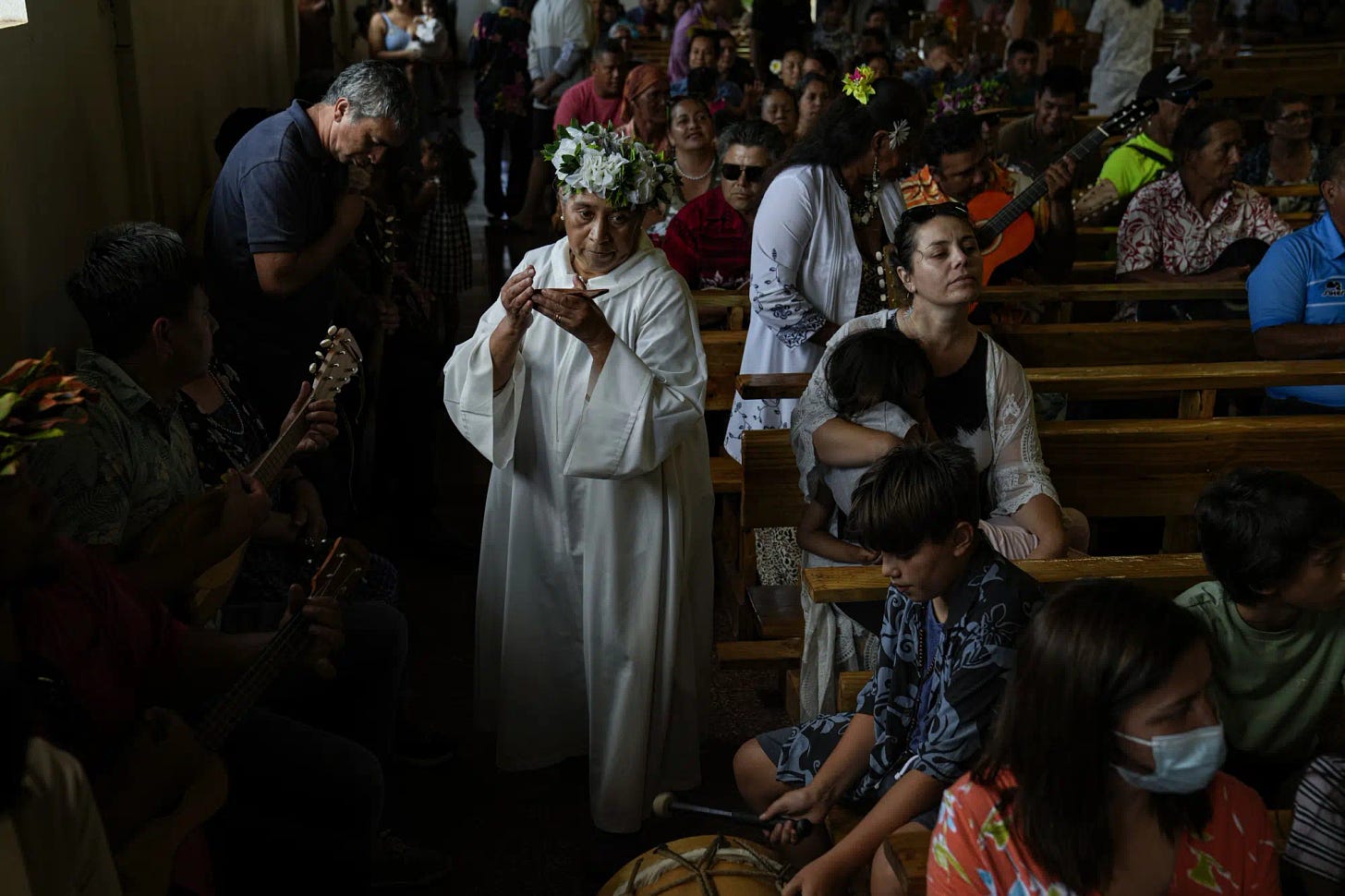 An acolyte carries the Eucharist after communion during Mass at the Church of the Holy Cross on Rapa Nui, or Easter Island, Chile, Sunday, Nov. 27, 2022. The first Europeans arrived to Rapa Nui in 1722, soon followed by missionaries, when Rapanui religiosity began to intertwine with Christianity. (AP Photo/Esteban Felix)