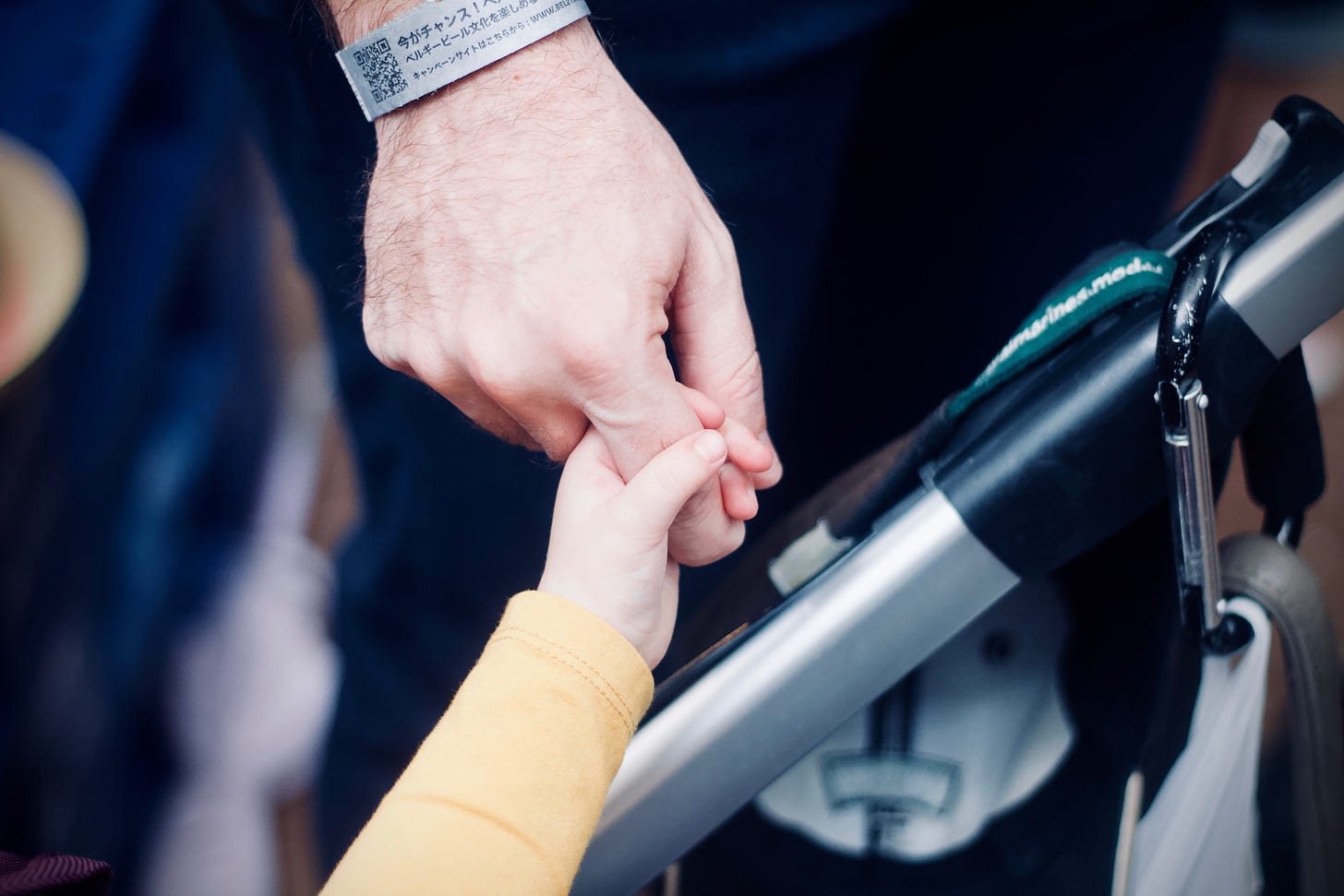 A small child’s hand grips onto the finger of an adult’s hand (Photo by Jelleke Vanooteghem on Unsplash)