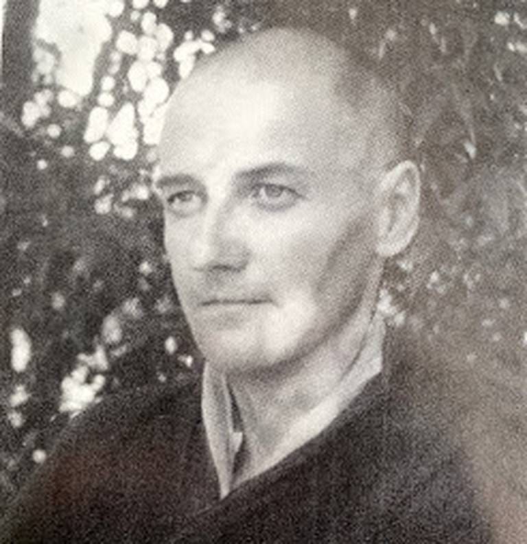 Black and white image of Michael Dillon, with no hair, after he became a Buddhist monk. Looking to the left of the picture and angular
