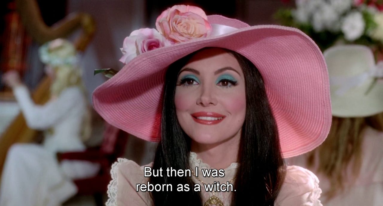 Elaine in a beautiful, pink sunhat saying "But then I was reborn as a witch."