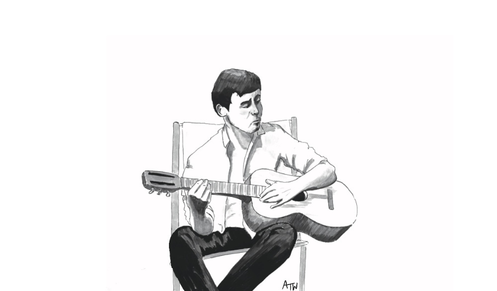 A young Paul McCartney playing guitar in his garden