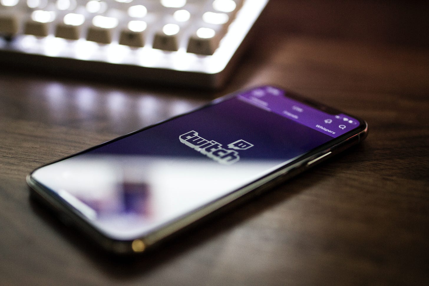Twitch app shown on a phone laid on a desk. Caspar Camille Rubin / Unsplash