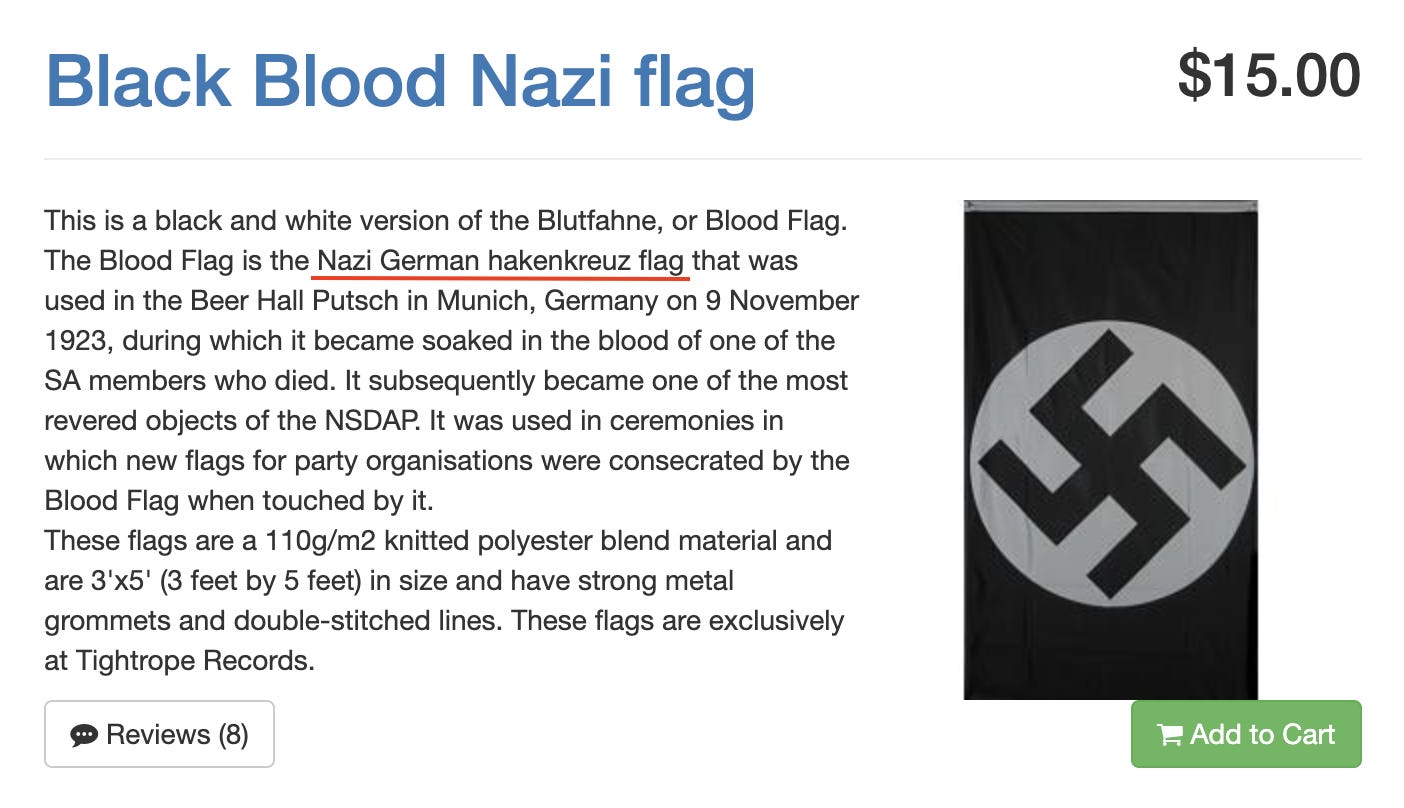 White background with a blue title at top left: “Black Blood Nazi flag”. Top right it reads: “$15.00”. Below on the left is text in black font that reads: “This is a black and white version of the Blutfahne, or Blood Flag. The Blood Flag is the Nazi German hakenkreuz flag that was used in the Beer Hall Putsch in Munich, Germany on 9 November 1923, during which it became soaked in the blood of one of the SA members who died. It subsequently became one of the most revered objects […]”