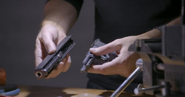 Jeremy White, a graphics editor at The Times, assembling a Glock 19 kit that was bought online. 