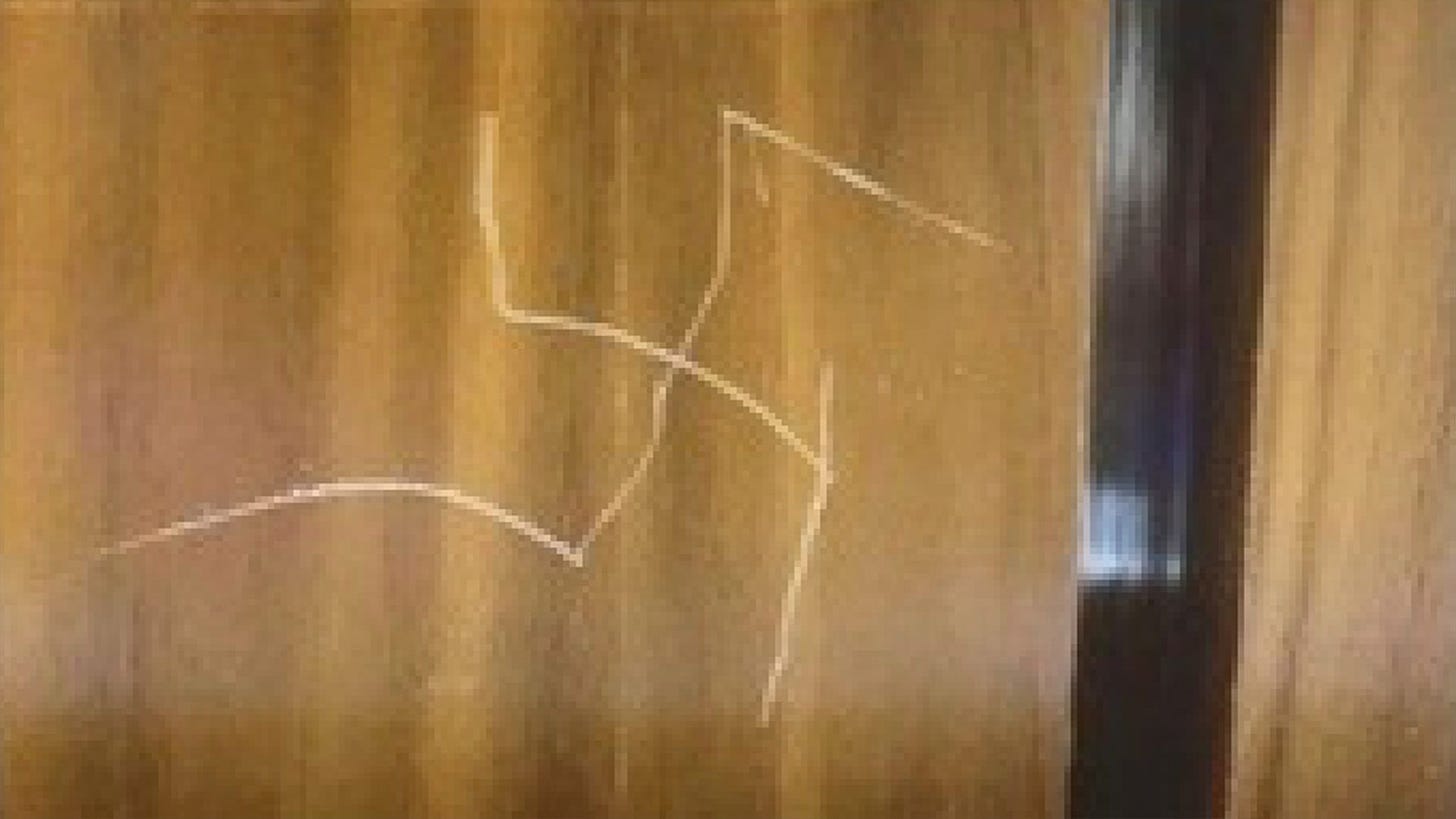 A swastika is seen etched into the wall of a State Department elevator.
