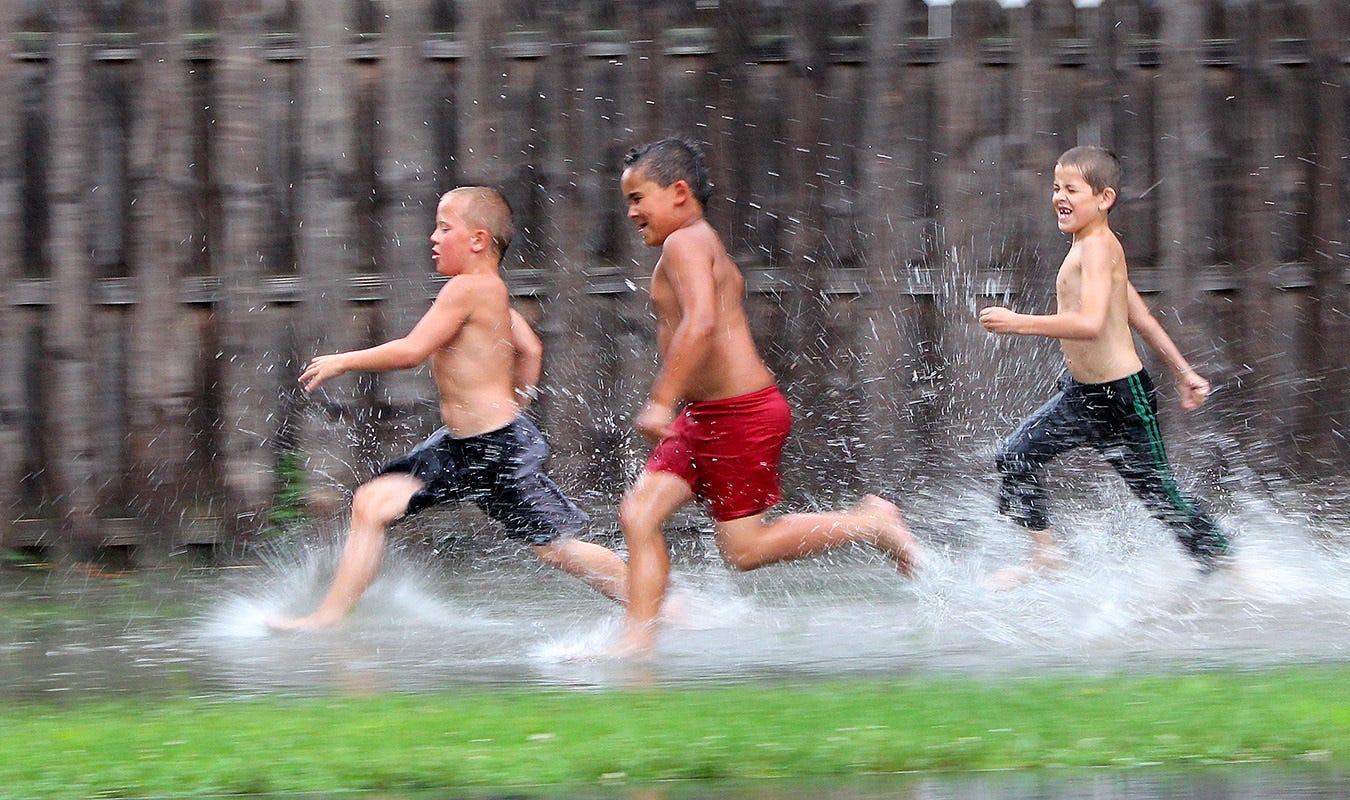 A deluge of spring rain left pools of water in neighborhoods, where eager kids race and splash for fun. As a community newspaper publisher, a big part of my job involves photographing children doing their various activities. This always delights our readers, and the kids, well, they become instant “celebrities” for the week.