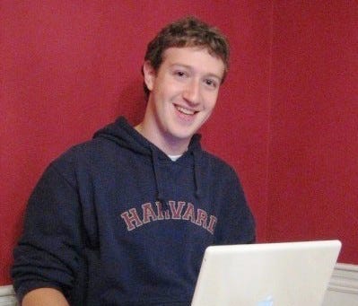 Mark Zuckerberg with a laptop, facing the camera