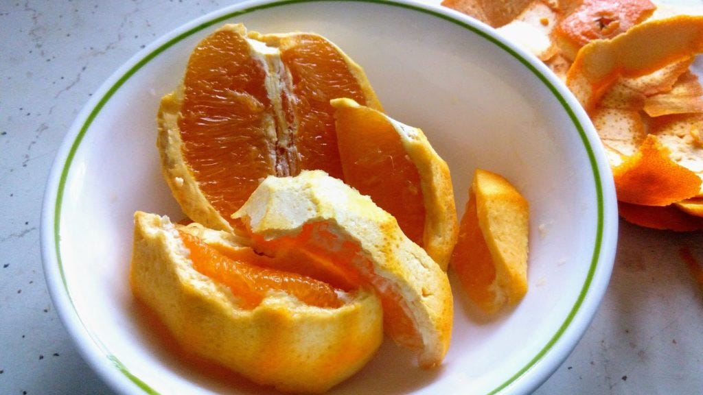 An orange peeled so the white pith remains.