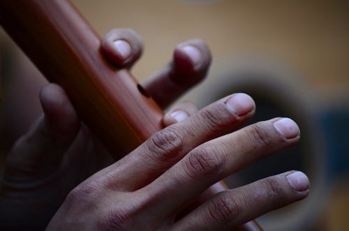 Closeup of fingers playing flute