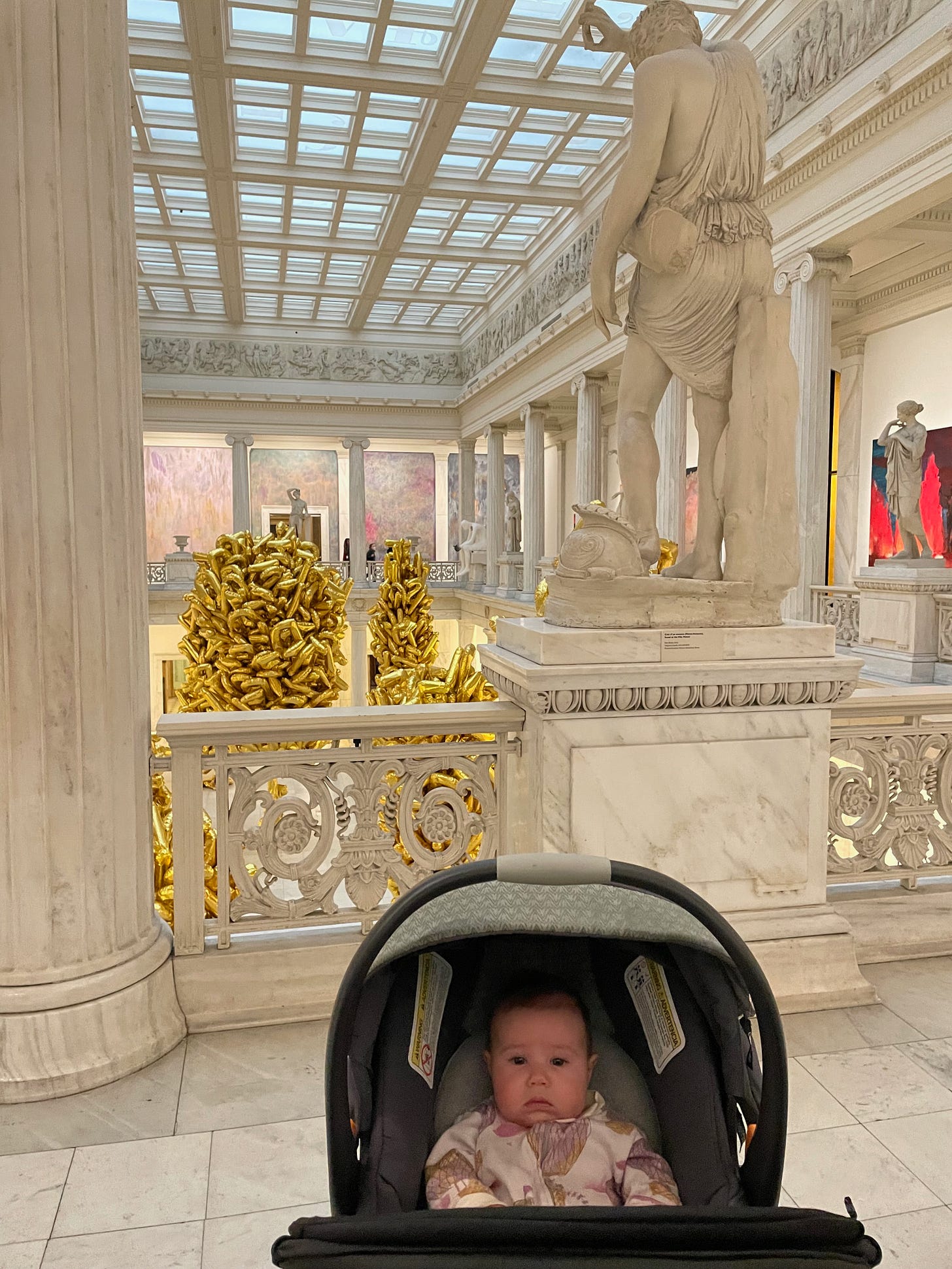 Baby in stroller in art museum.