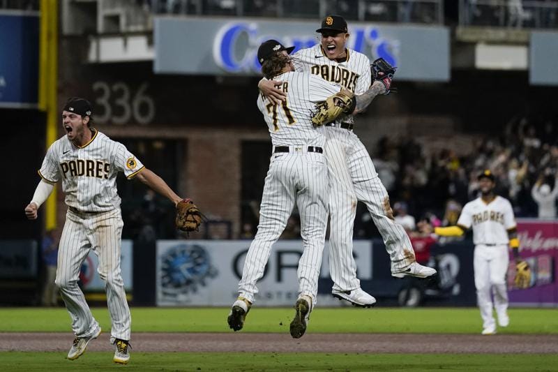 San Diego Padres third baseman Manny Machado, right, celebrates with relief pitcher Josh Hader (71) after the Padres defeated the Los Angeles Dodgers 5-3 in Game 4 of a baseball NL Division Series, Saturday, Oct. 15, 2022, in San Diego. (AP Photo/Ashley Landis)