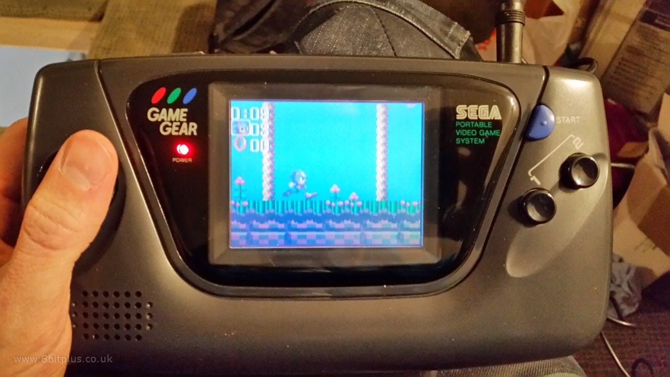 Photo of a Sega Game Gear handheld console playing Sonic 2