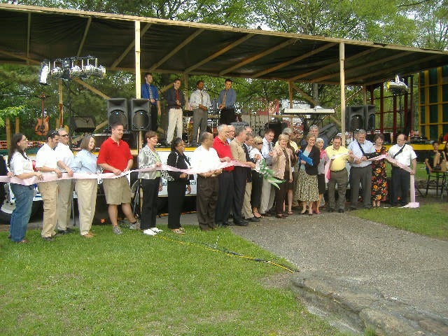 All the politicians holding the ribbon are waiting with bated breath - for their photo-op to be finished.