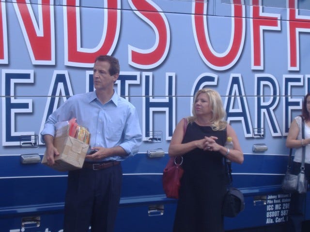 Standing with local AFP co-chair Julie Brewington (right), Tim Phillips holds 1,100 petitions collected through the First Congressional District - out of 220,000 nationwide.