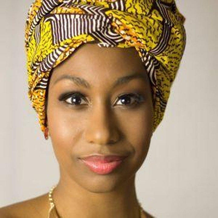 An image of Bombazo Dance Co.'s founder, Mrs. Tucker. It is a professional headshot and she is wearing a beautiful yellow printed and designed headscarf.