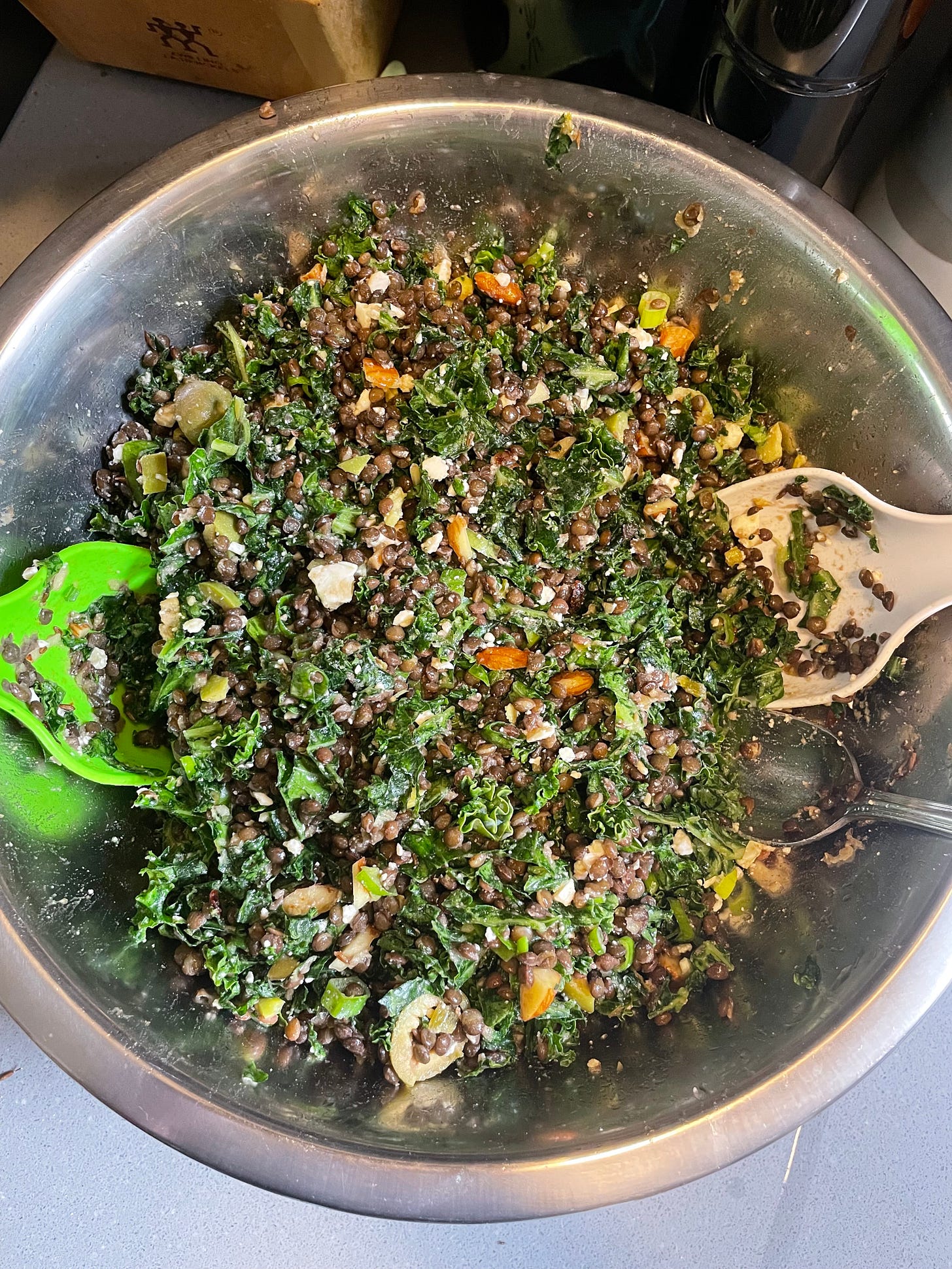 lentil and kale salad in silver bowl