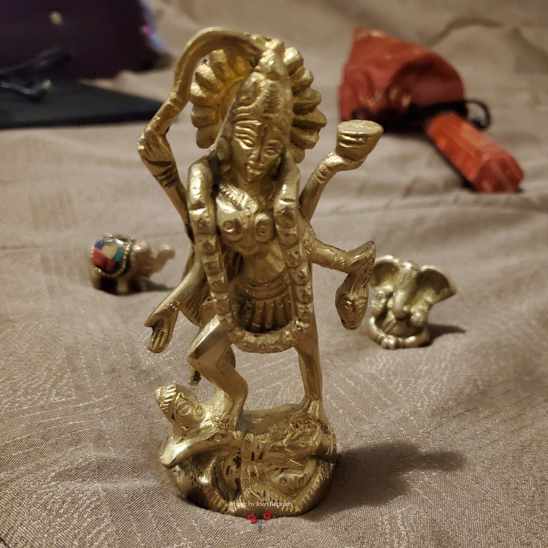 Ma Kali murti with lord Ganesha murti around her placed on a bed