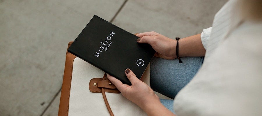 Person holding a Mission journal