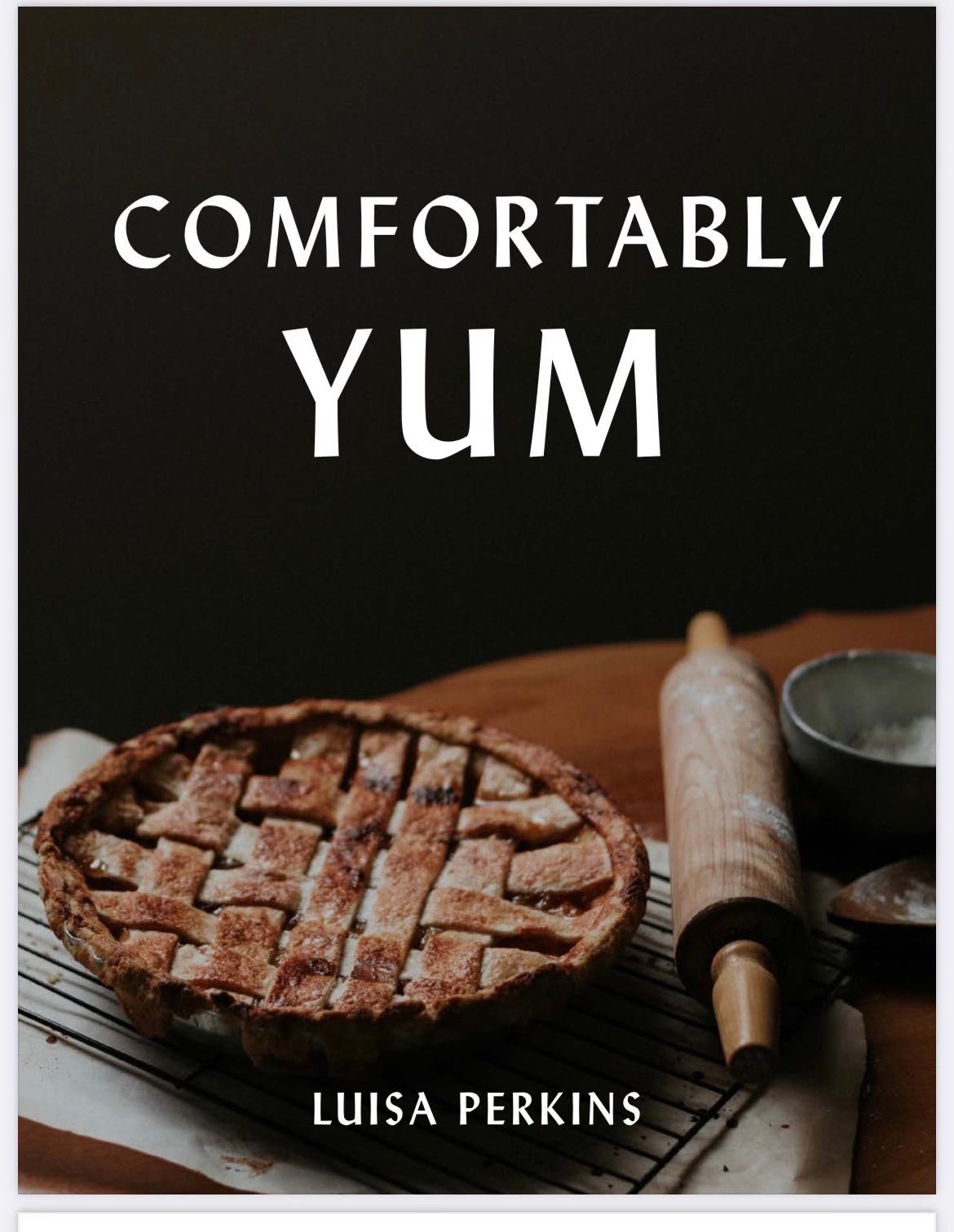 Cover of Comfortably Yum cookbook with a rolling pin and apple pie pictured
