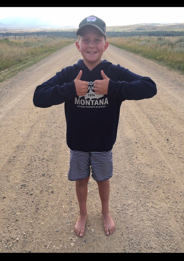 A child standing on a dirt road

Description automatically generated with low confidence