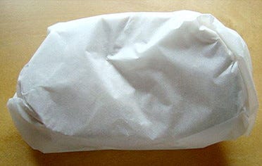 Bread wrapped in parchment paper.