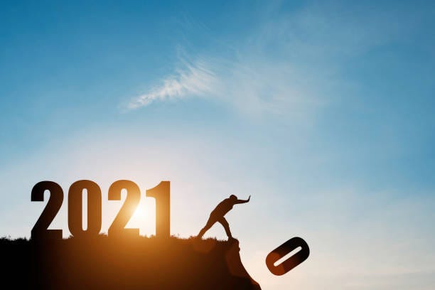 l’homme pousse le numéro zéro vers le bas de la falaise où a le nombre 2021 avec le ciel bleu et le lever du soleil. il est le symbole du début et bienvenue bonne année 2021. - 2021 photos et images de collection