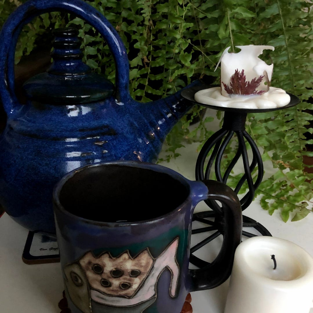 Cobalt blue teapot, ugly fish mug, and clandles