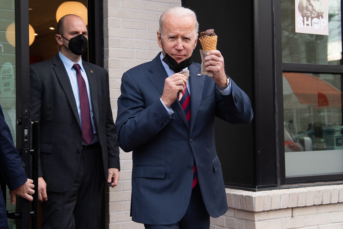 US President Joe Biden carries an ice cream cone as he leaves Jeni's Ice Cream in Washington, DC, on January 25, 2022. (Photo by SAUL LOEB / AFP) (Photo by SAUL LOEB/AFP via Getty Images)