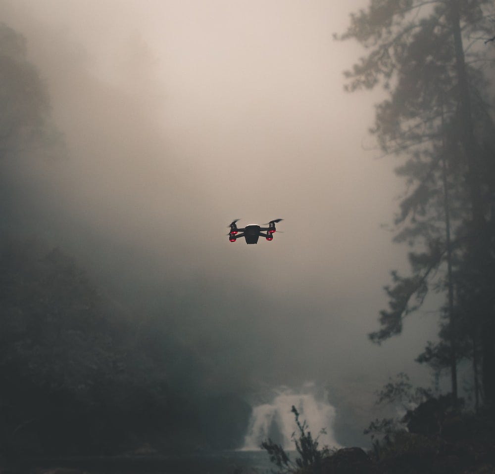 selective-focus photography of flying drone
