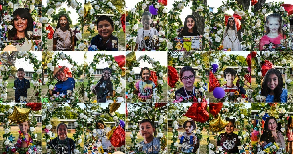 Photos of 19 children and 2 teachers who died in the mass shooting are displayed at a makeshift memorial.