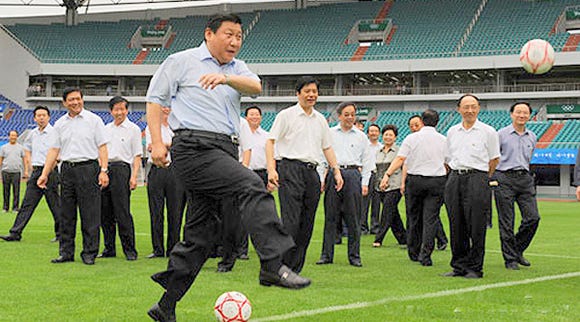 Xi Jinping kicks a football