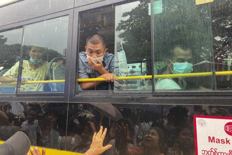 A man looks out from a bus window as people look for their family members and relatives on a bus carrying prisoners who released from Insein Prison Thursday, Nov. 17, 2022, in Yangon, 2022, in Yangon, Myanmar. The country's military-controlled government announced Thursday it was releasing and deporting an Australian academic, a Japanese filmmaker, an ex-British diplomat and an American as part of a broad prisoner amnesty to mark the country’s National Victory Day. (AP Photo)