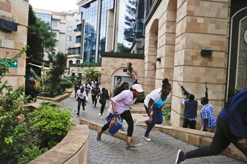 Civilians flee as security forces aim their weapons at a hotel complex attacked by al-Shabab extremists, in Nairobi, Kenya on Jan. 15, 2019. Facebook has failed to catch Islamic State group and al-Shabab extremist content in posts aimed at East Africa as the region remains under threat from violent attacks and Kenya prepares to vote in a closely contested national election, according to a new study released Wednesday, June 15, 2022.