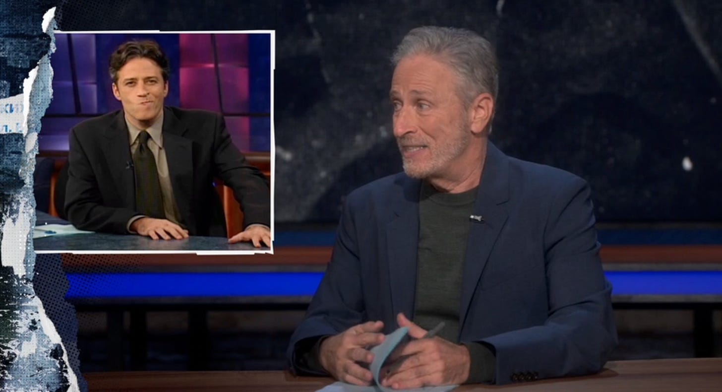 Jon Stewart looking at an old picture of himself.