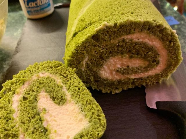 A fluffy green roll with a white swirl in the middle