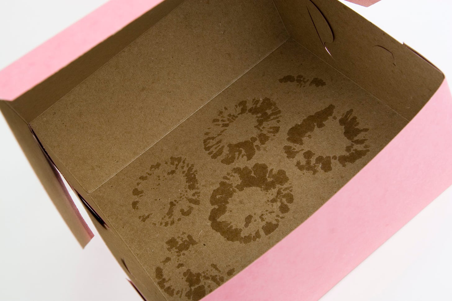 An empty box with greasy donut marks