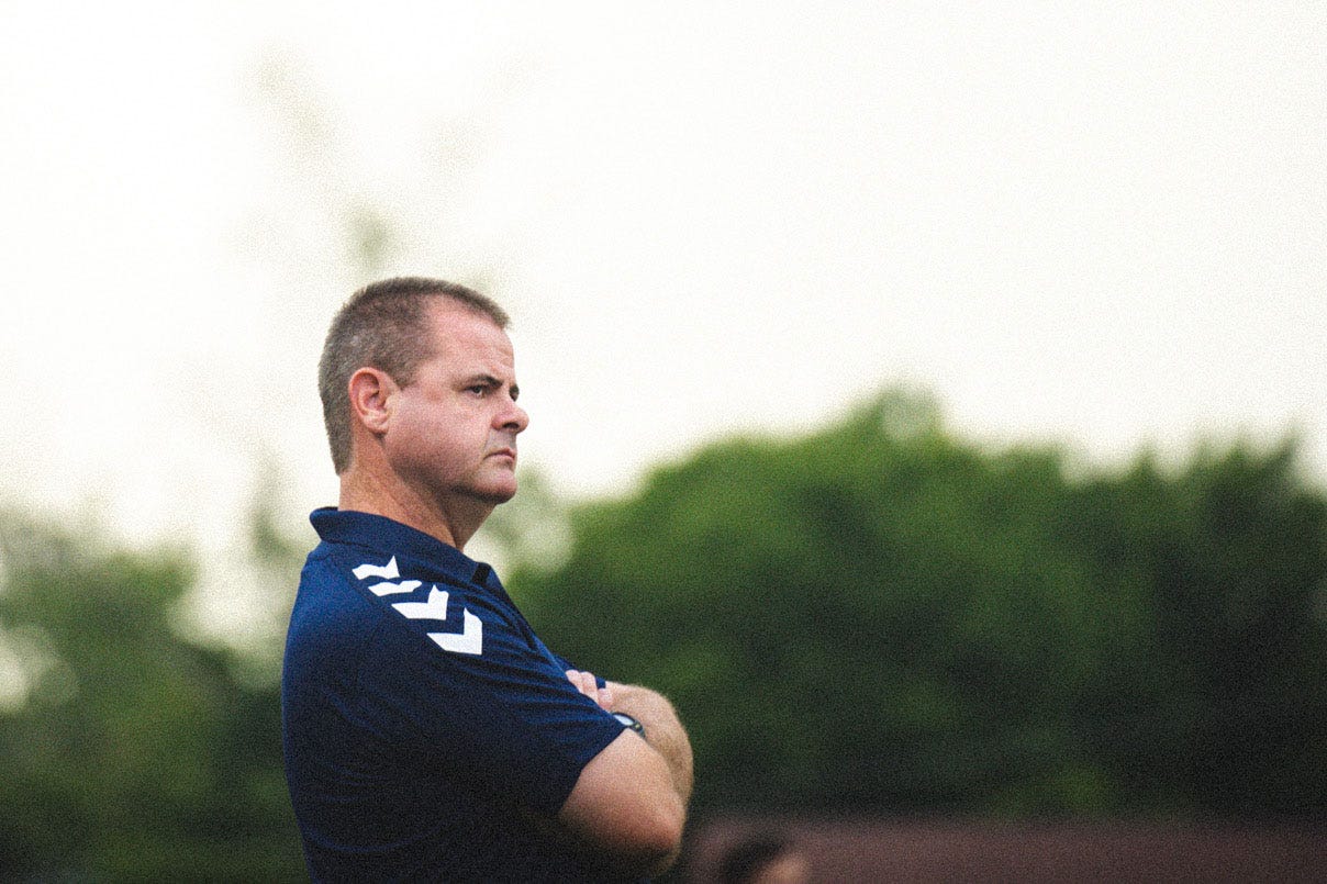 Mark McKeever staring at a soccer field.