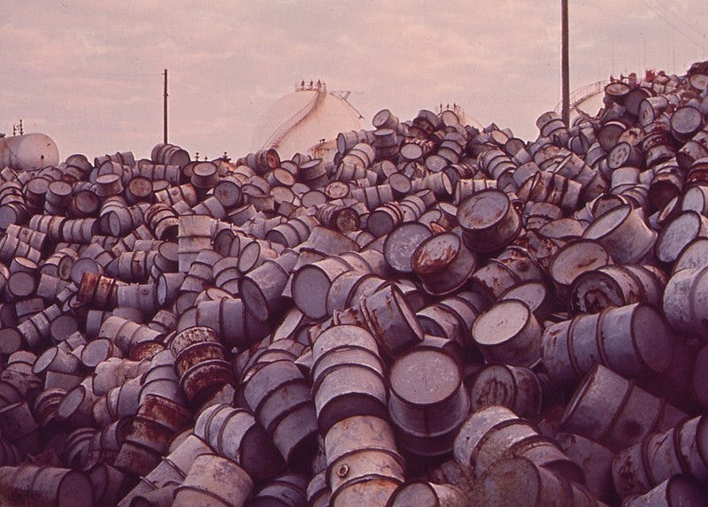 File:A MOUNTAIN OF DAMAGED OIL DRUMS NEAR THE EXXON REFINERY - NARA - 546000 (cropped).jpg