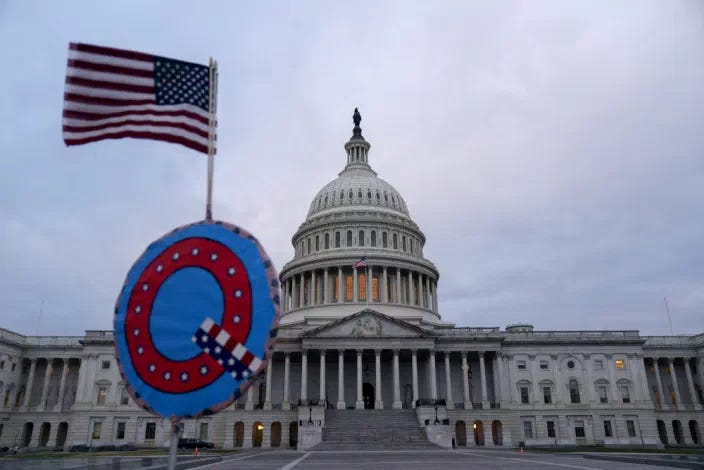 A demonstrator holds a &quot;Q&quot; sign outside the U.S. Capitol in Washington on Wednesday, Jan. 6, 2021. (Stefani Reynolds/Bloomberg via Getty Images)