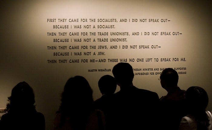 Visitors stand in front of the quotation from Martin Niemöller that is on display in the Permanent Exhibition of the United States ... [LCID: img4857]