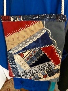 A hand made crazy quilt bag embellished with embroidery and lace.