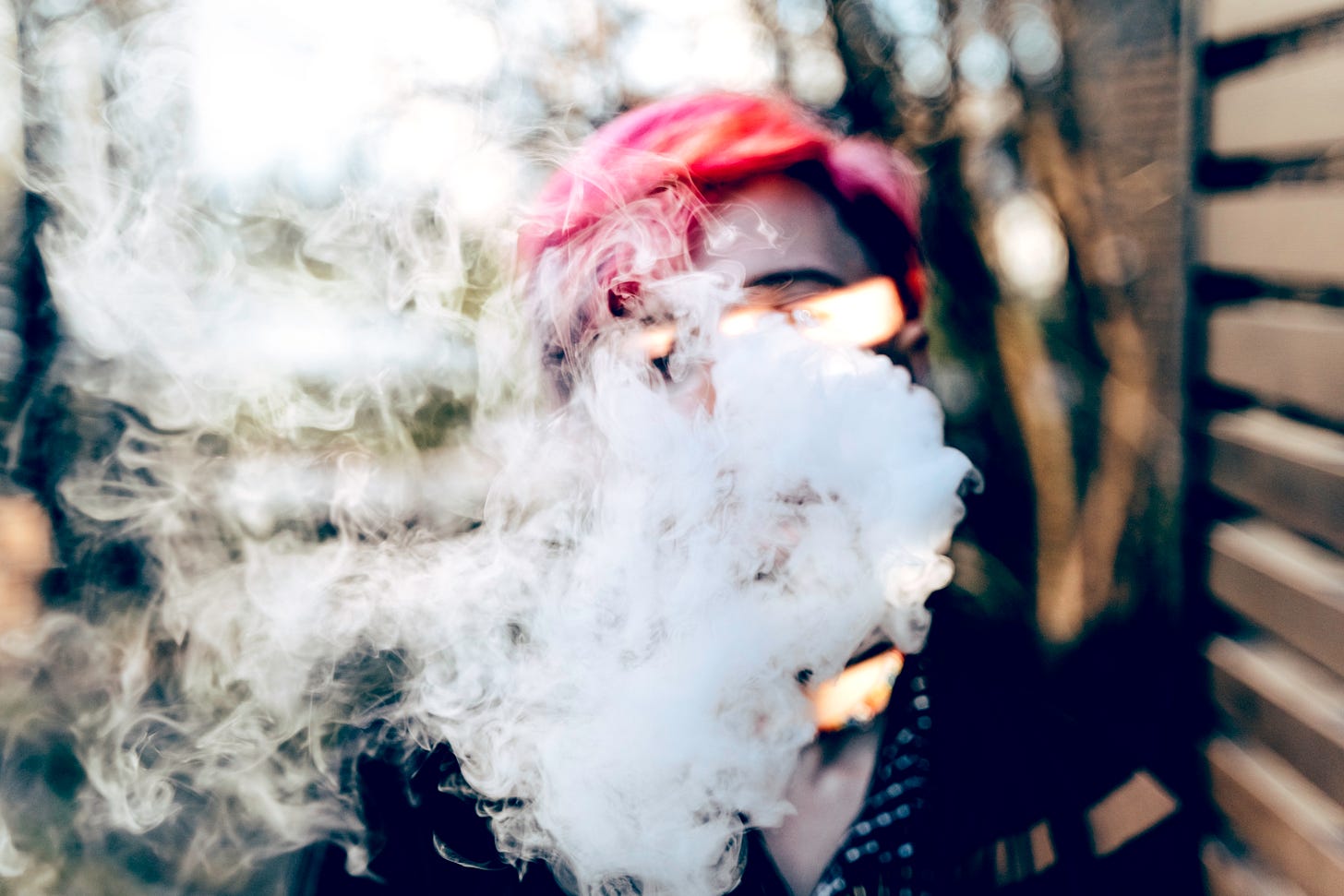 Person with multihued red hair and possibly a red hat whose face is nearly completely obscured by weird white fog