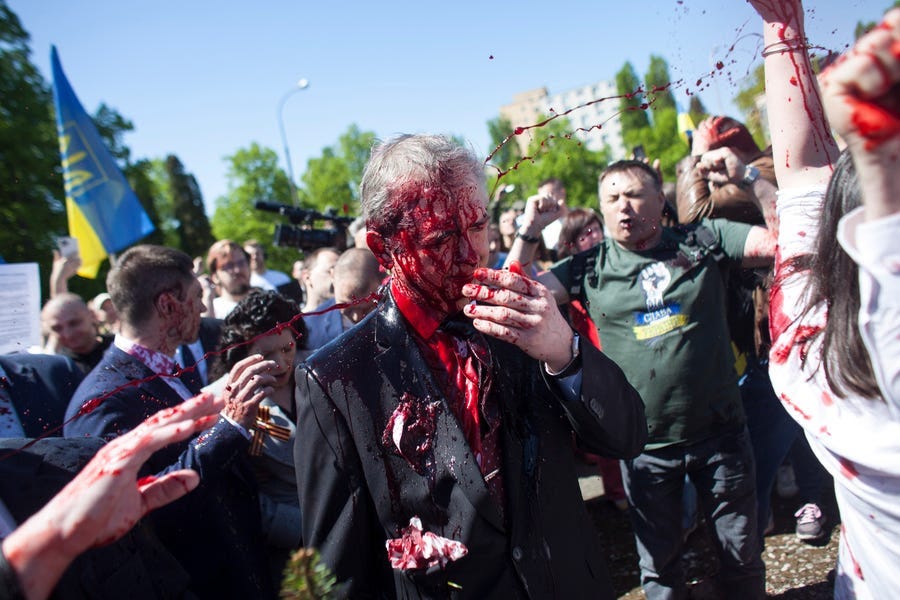 May 9, 2022:  Russian Ambassador to Poland, Ambassador Sergey Andreev is covered with red paint in Warsaw, Poland. Protesters threw red paint on the Russian ambassador as he arrived at a cemetery in Warsaw to pay respects to Red Army soldiers who died during World War II. Ambassador Sergey Andreev arrived at the Soviet soldiers cemetery on Monday to lay flowers where a group of activists opposed to Russia’s war in Ukraine were waiting for him.