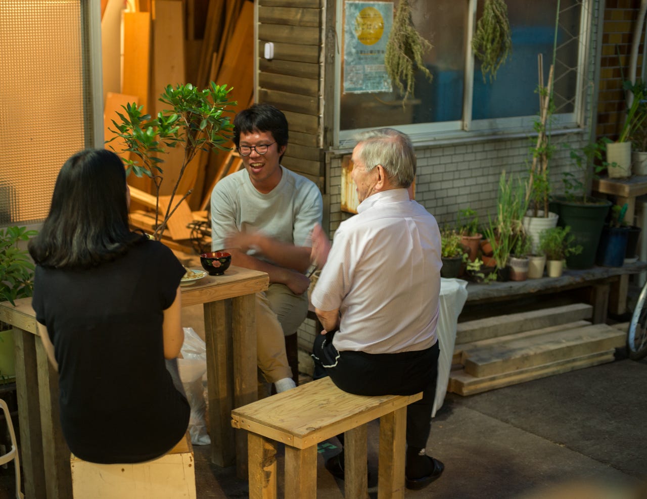Neighbors enjoy food and drink outside a home in an alleyway in Osaka, Japan Neighbors enjoy food and drink outside a home in an alleyway in Osaka, Japan