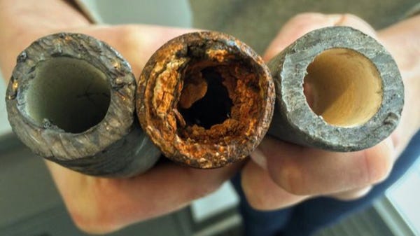 An image provided by the Environmental Protection Agency shows examples of a lead pipe, left, a corroded steel pipe, center, and a lead pipe treated with protective orthophosphate. 