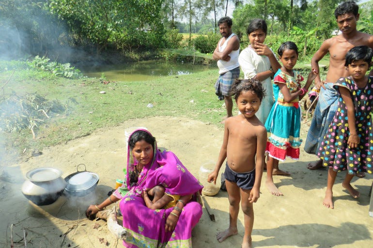 Women and children outside their house at Sagar Island in the Sundarbans [Namrata Acharya/Al Jazeera]