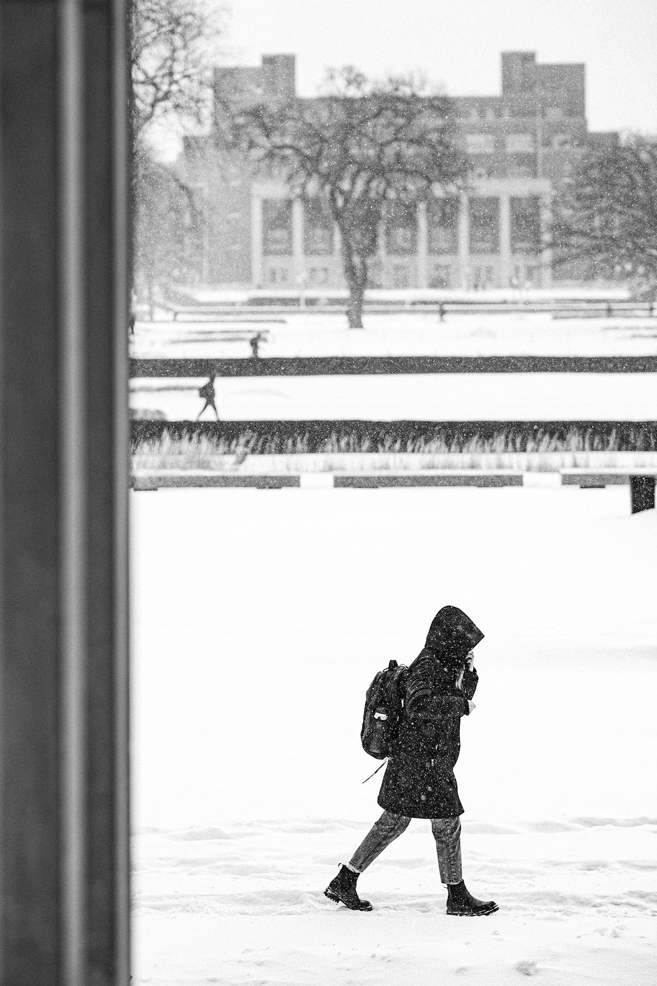 Students cross the quad in front of the Coffman Union during a heavy snowstorm. 